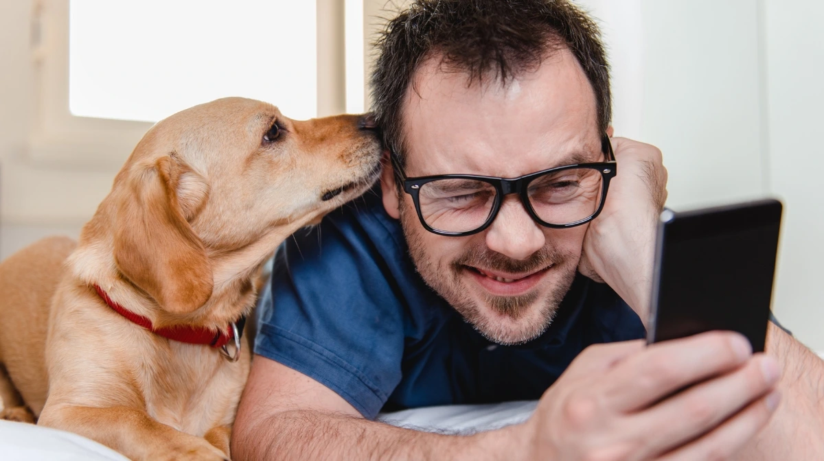 Man Reading Newsletter with Dog